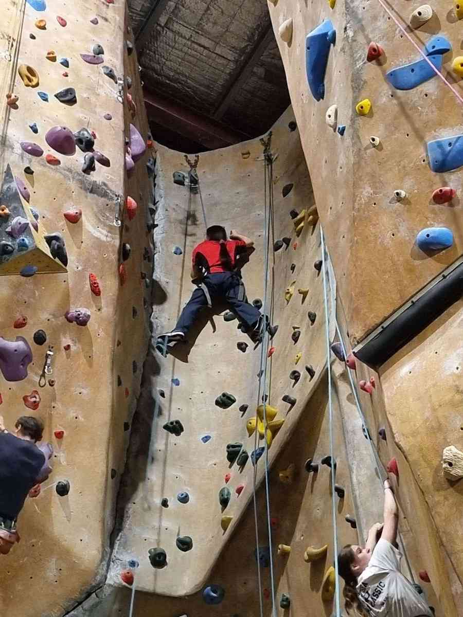 Venturers doing rock climbing