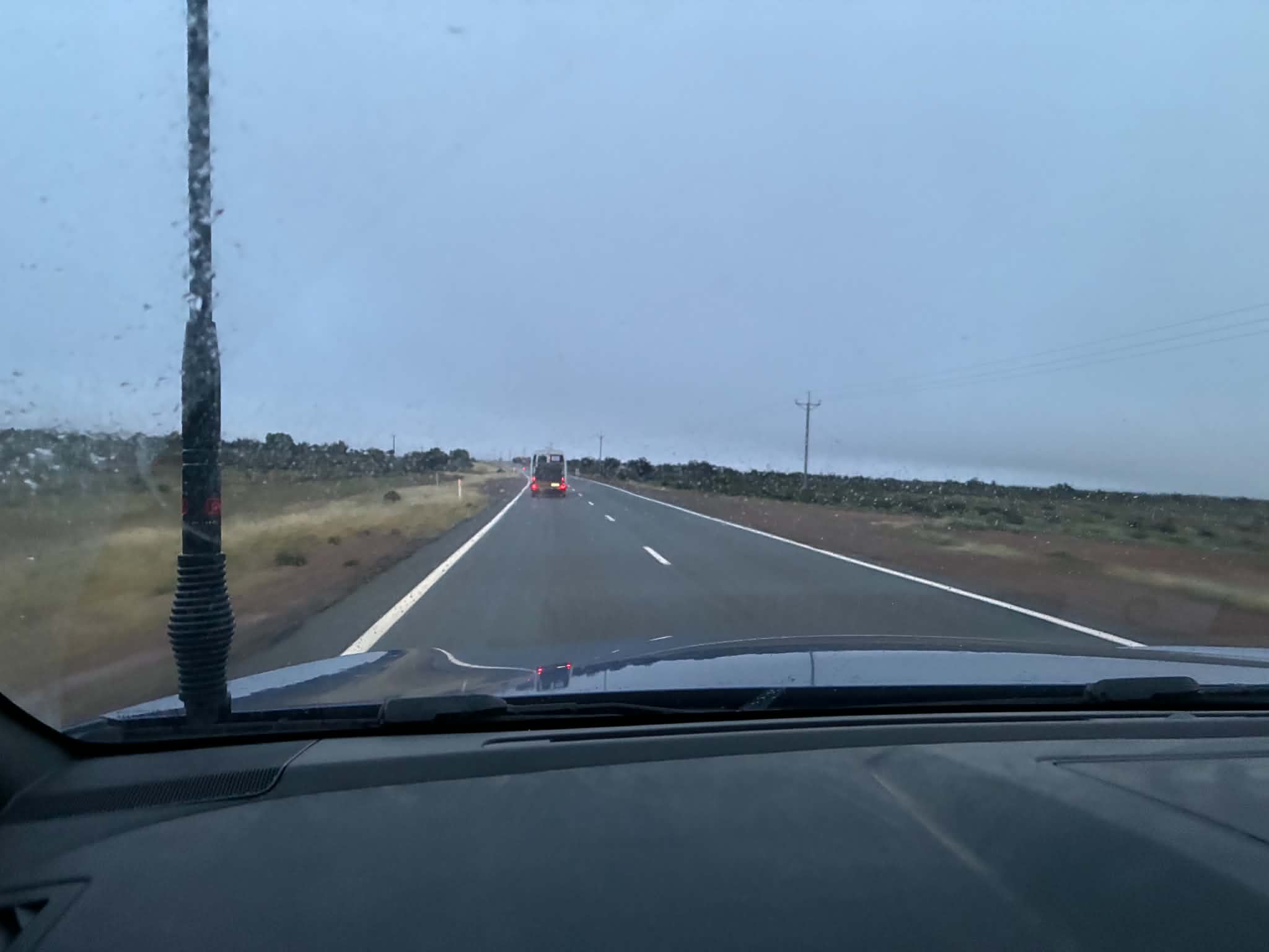 Uluru expedition convoy driving through wet conditions on the road from Broken Hill to Coober Pedy