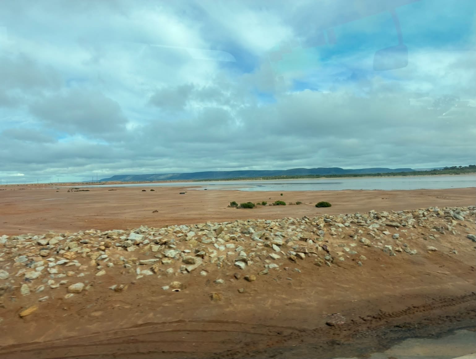 Salt lake and distant hills seen from the Uluru expedition convoy