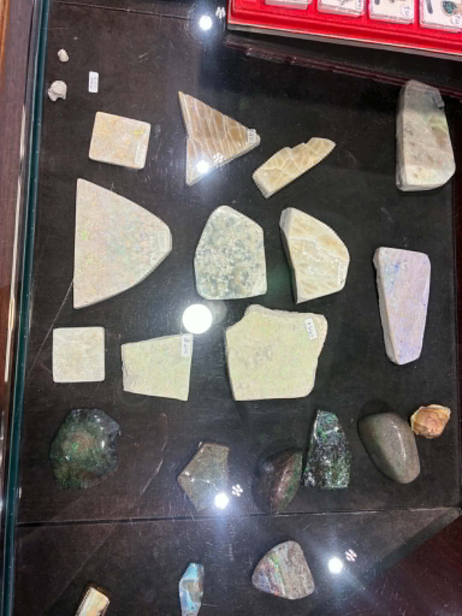 Polished opal samples displayed in a glass cabinet at Coober Pedy
