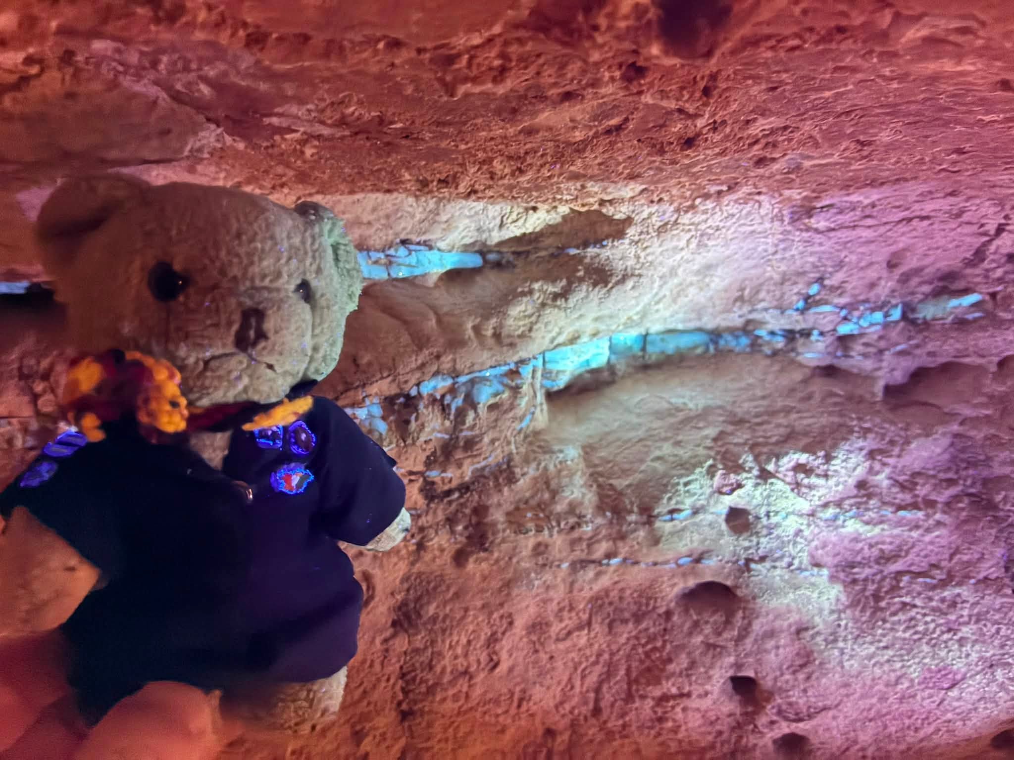 Uluru expedition mascot inside a colourful underground sandstone passage at Coober Pedy