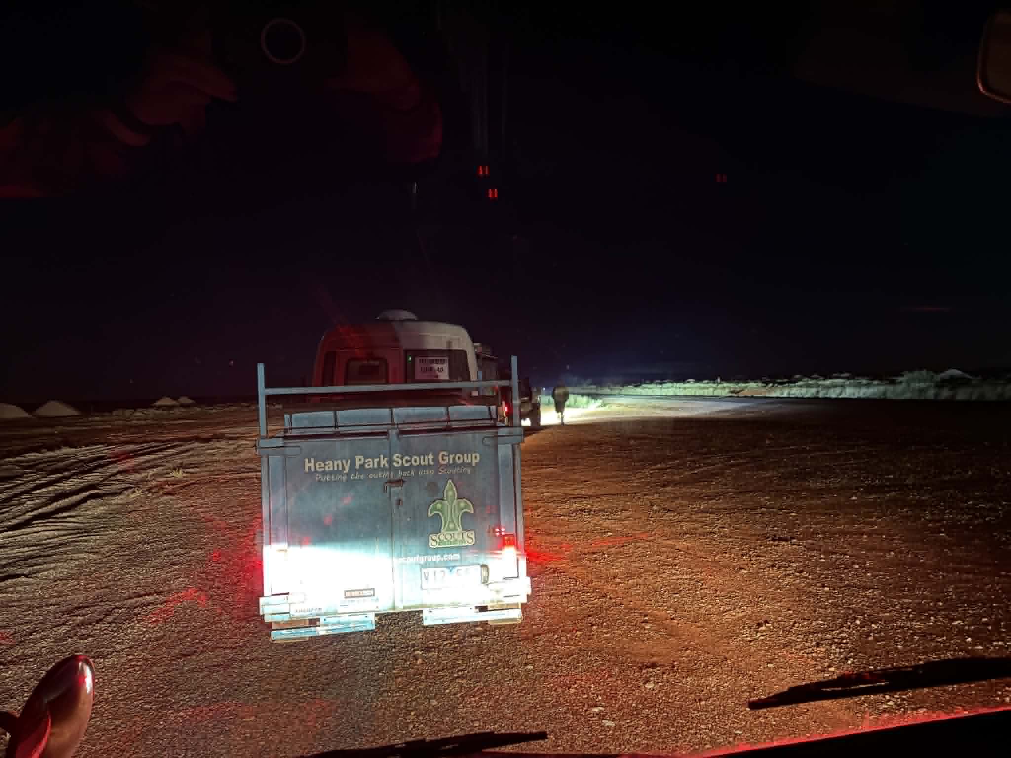 Uluru expedition convoy driving before dawn on the road to the red centre