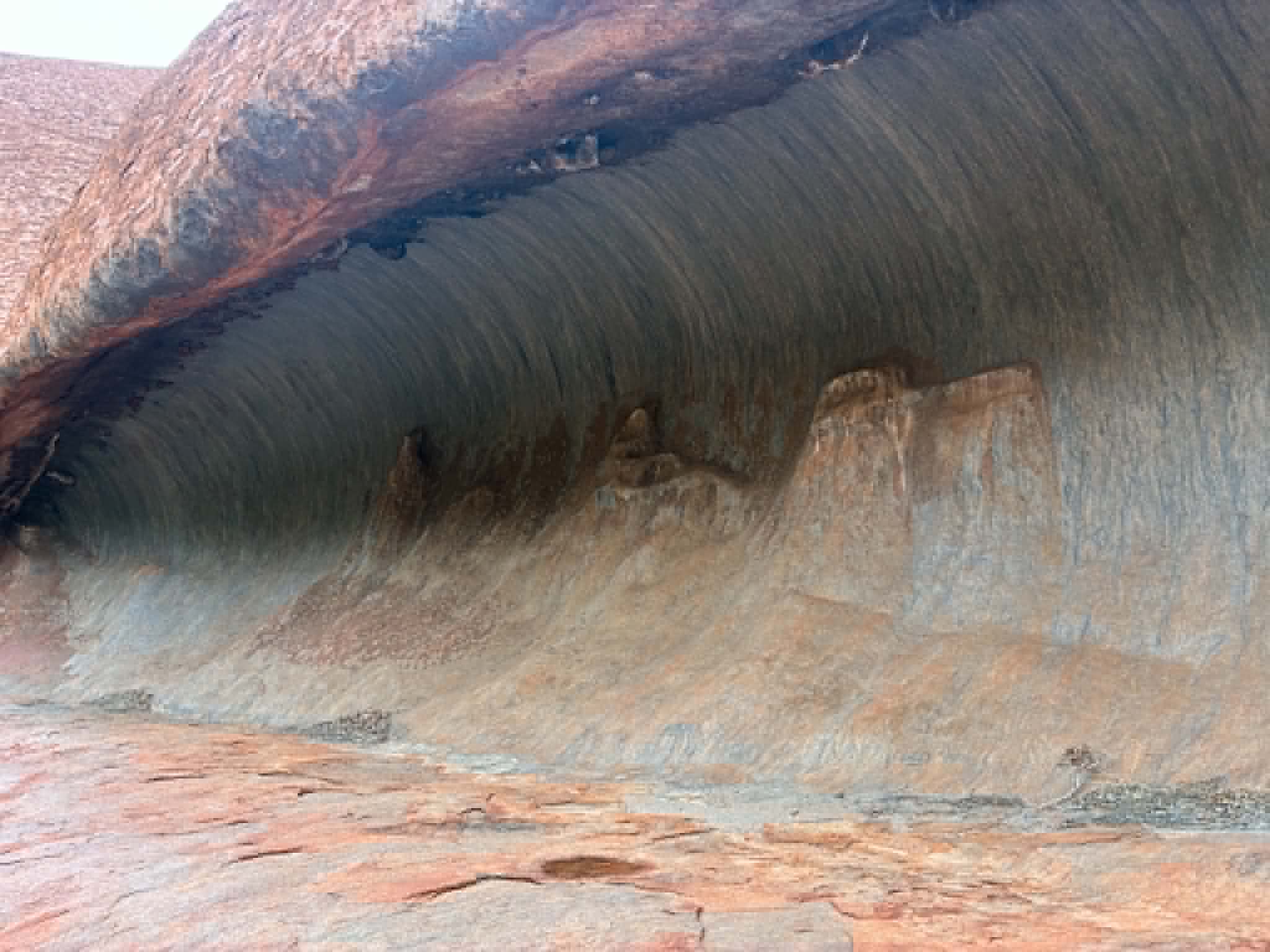 Close view of Uluru rock formations and shaded overhangs
