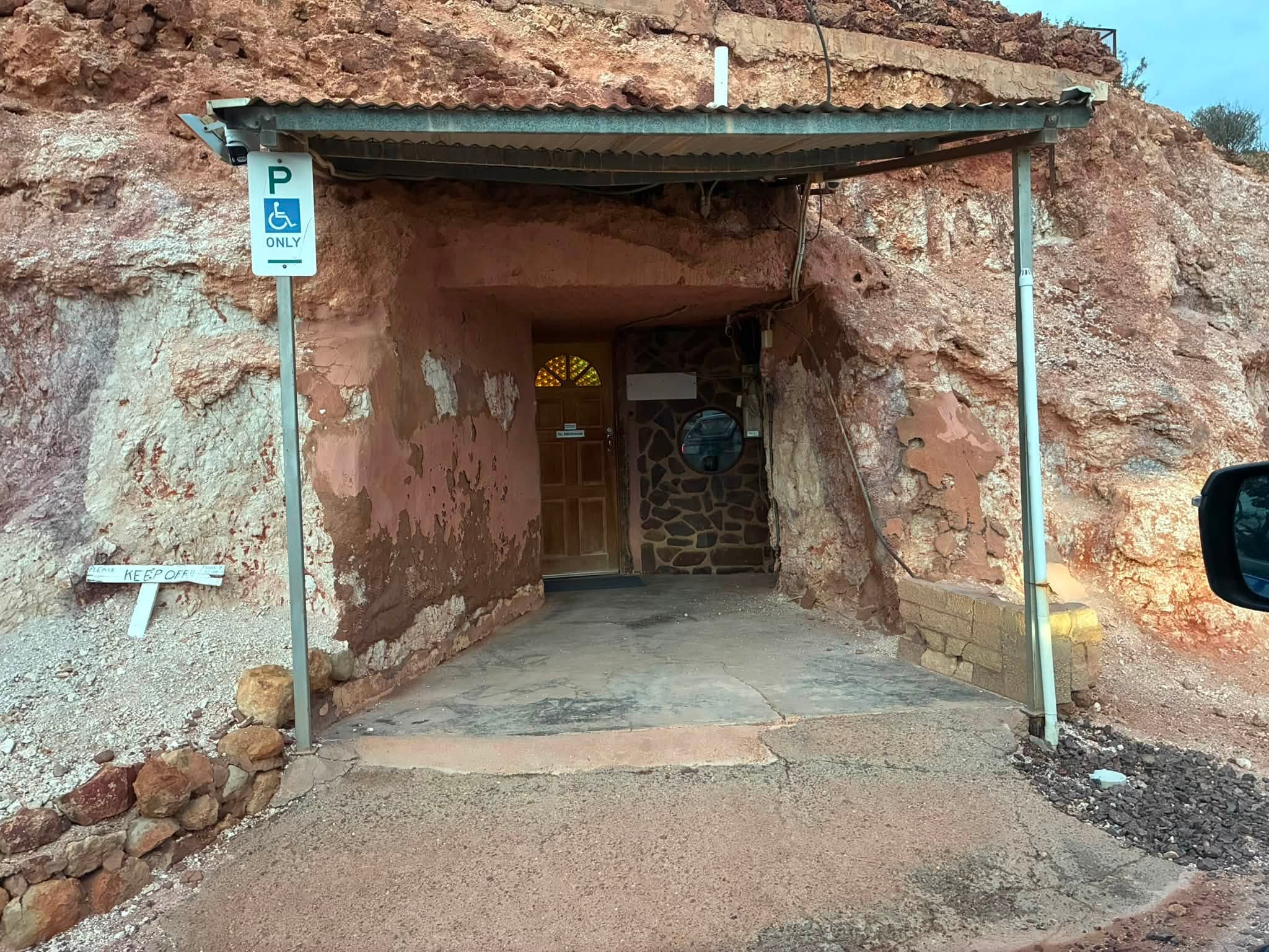 Entrance to an underground dugout building in Coober Pedy cut into the red and white rock