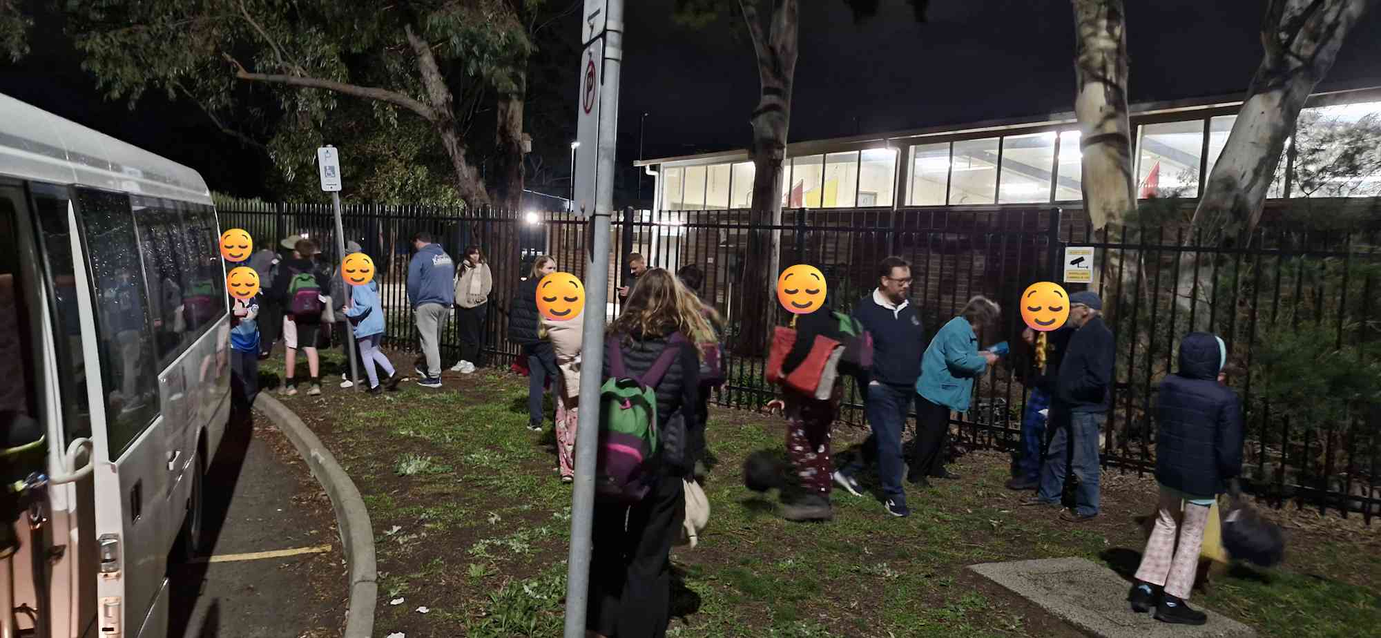 Uluru expeditioners collecting their bags and greeting families outside Bundoora Scout Hall after arriving home